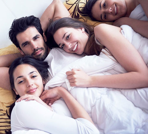 Group of swingers in bed